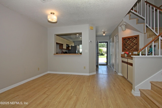 2105 Sandpiper Ct, Ponte Vedra Beach, FL 32082 - foyer featuring stairway, light wood finished floors, baseboards, and a textured ceiling