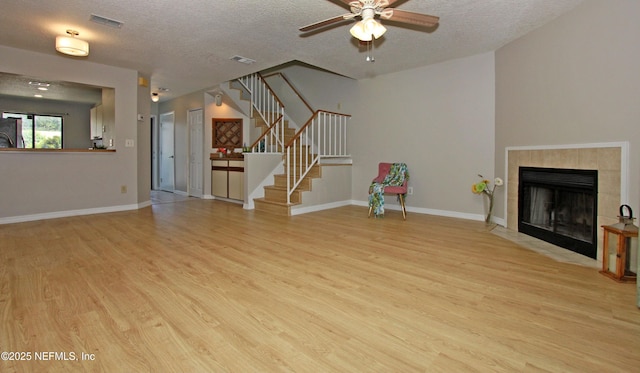 2105 Sandpiper Ct, Ponte Vedra Beach, FL 32082 - unfurnished living room with light wood-style floors, a textured ceiling, ceiling fan, stairs, and baseboards