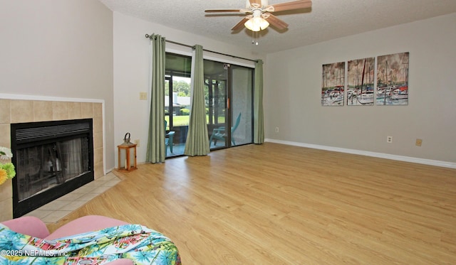 2105 Sandpiper Ct, Ponte Vedra Beach, FL 32082 - living room featuring wood finished floors, ceiling fan, a textured ceiling, a fireplace, and baseboards