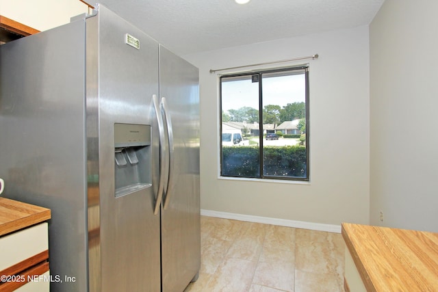 2105 Sandpiper Ct, Ponte Vedra Beach, FL 32082 - kitchen with stainless steel fridge, wood counters, and baseboards
