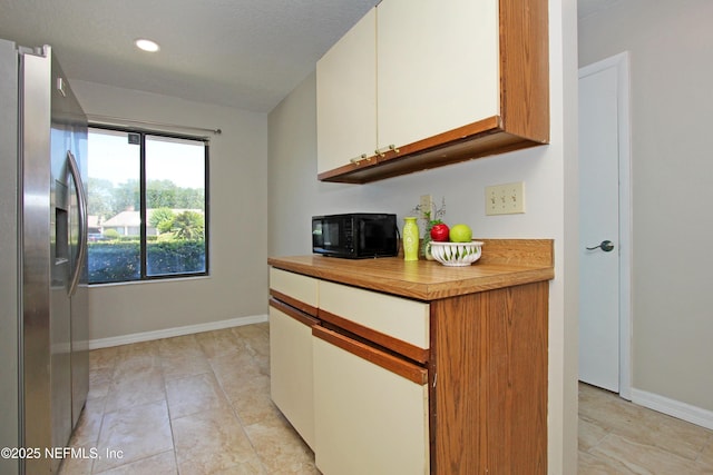 2105 Sandpiper Ct, Ponte Vedra Beach, FL 32082 - kitchen featuring stainless steel fridge with ice dispenser, black microwave, white cabinetry, baseboards, and recessed lighting