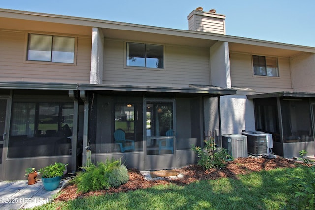 2105 Sandpiper Ct, Ponte Vedra Beach, FL 32082 - back of house with a sunroom, a chimney, and central air condition unit