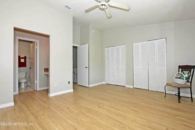 2105 Sandpiper Ct, Ponte Vedra Beach, FL 32082 - unfurnished bedroom featuring light wood-style flooring, multiple closets, a textured ceiling, baseboards, and high vaulted ceiling