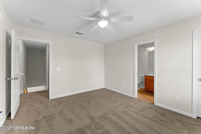 4778 Playpen Dr, Jacksonville, FL 32210 - unfurnished bedroom with carpet floors, a textured ceiling, baseboards, ensuite bathroom, and a ceiling fan