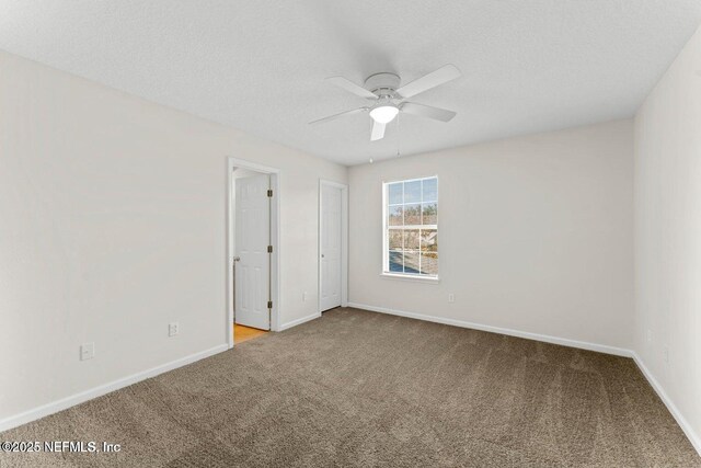 4778 Playpen Dr, Jacksonville, FL 32210 - empty room with carpet flooring, a ceiling fan, baseboards, and a textured ceiling