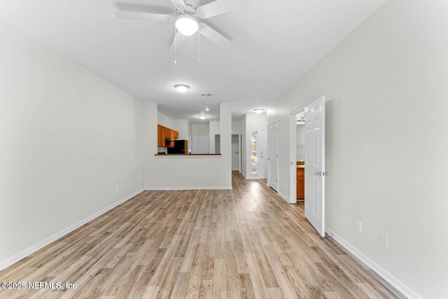 4778 Playpen Dr, Jacksonville, FL 32210 - unfurnished living room with light wood-style floors, baseboards, and ceiling fan
