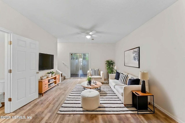 4778 Playpen Dr, Jacksonville, FL 32210 - living area featuring a ceiling fan, light wood-style floors, and baseboards