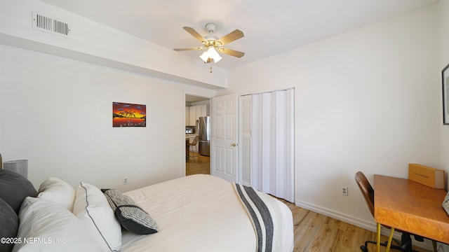 119 Moore St, Saint Augustine, FL 32084 - bedroom featuring freestanding refrigerator, light wood-style floors, baseboards, a closet, and ceiling fan
