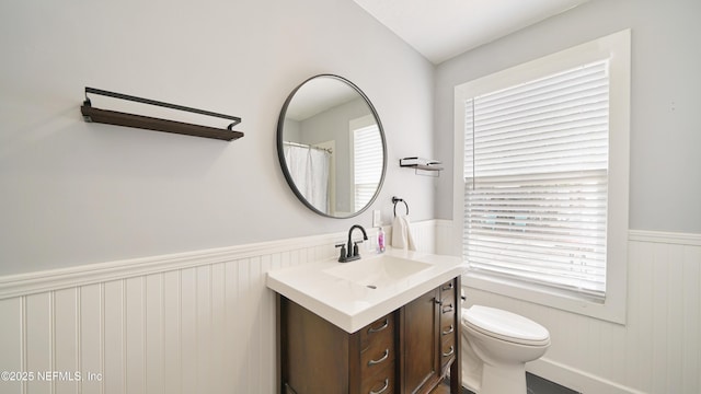 119 Moore St, Saint Augustine, FL 32084 - bathroom featuring wainscoting, vanity, and toilet