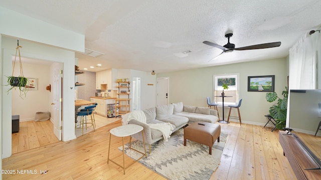 119 Moore St, Saint Augustine, FL 32084 - living area with light wood-style floors, a ceiling fan, baseboards, a textured ceiling, and recessed lighting