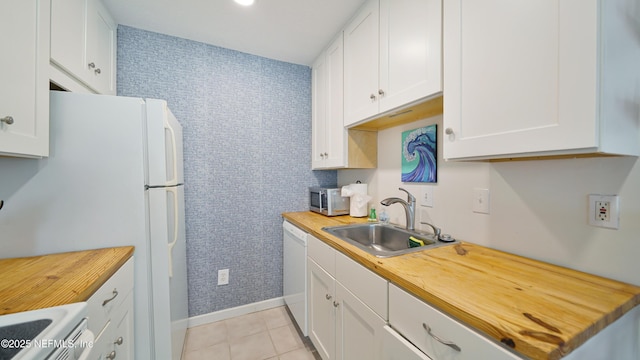 119 Moore St, Saint Augustine, FL 32084 - kitchen featuring a sink, wood counters, white appliances, white cabinets, and wallpapered walls