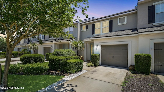 18 Amistad Dr, Saint Augustine, FL 32086 - townhome / multi-family property with a garage, stucco siding, and concrete driveway