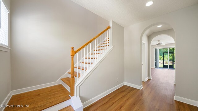 18 Amistad Dr, Saint Augustine, FL 32086 - stairway featuring baseboards, wood finished floors, arched walkways, and recessed lighting