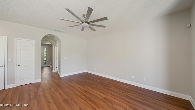 18 Amistad Dr, Saint Augustine, FL 32086 - empty room with arched walkways, ceiling fan, wood finished floors, baseboards, and a textured ceiling