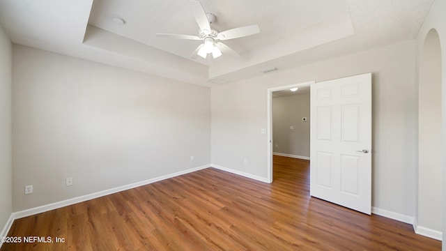 18 Amistad Dr, Saint Augustine, FL 32086 - empty room with a tray ceiling, wood finished floors, baseboards, and a ceiling fan