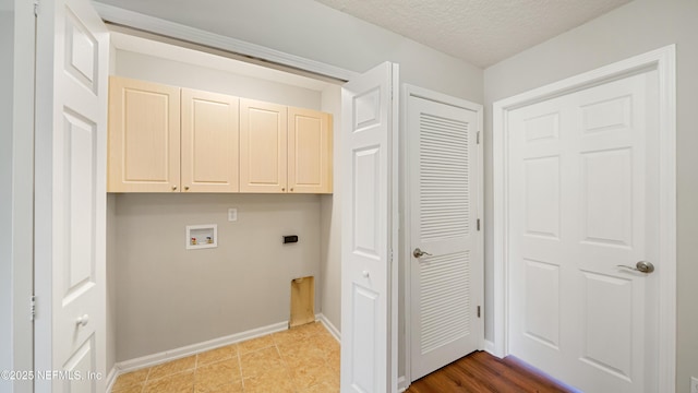 18 Amistad Dr, Saint Augustine, FL 32086 - laundry area featuring cabinet space, hookup for a washing machine, baseboards, a textured ceiling, and hookup for an electric dryer