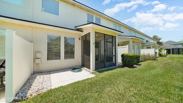 18 Amistad Dr, Saint Augustine, FL 32086 - rear view of property with a sunroom, a lawn, and a patio