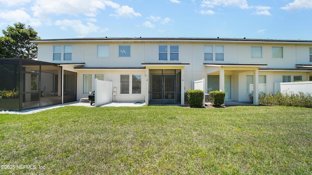 18 Amistad Dr, Saint Augustine, FL 32086 - back of house with a sunroom, stucco siding, and a yard