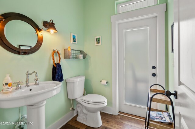 211 Tenth St, Saint Augustine, FL 32084 - bathroom with wood finished floors, baseboards, and toilet