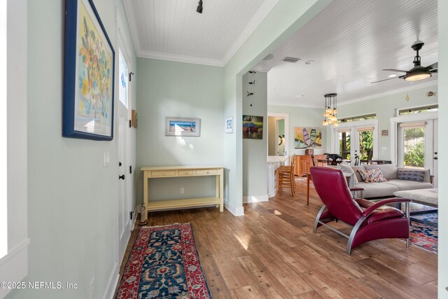 211 Tenth St, Saint Augustine, FL 32084 - living area featuring french doors, hardwood / wood-style flooring, baseboards, crown molding, and ceiling fan