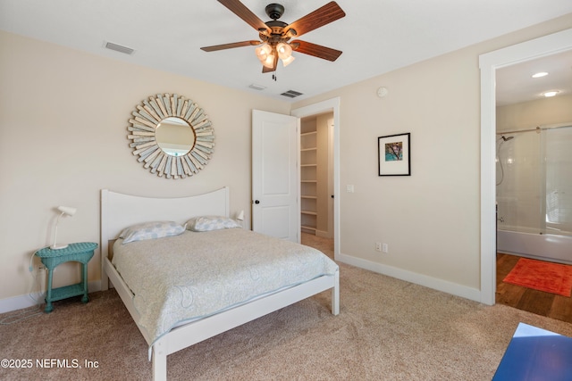211 Tenth St, Saint Augustine, FL 32084 - bedroom with carpet, baseboards, ensuite bathroom, a ceiling fan, and a walk in closet