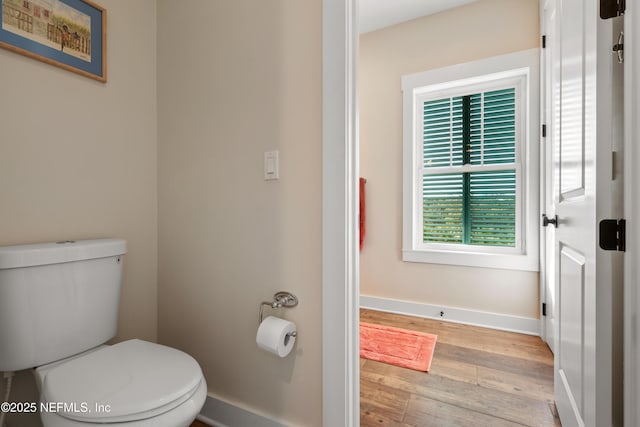 211 Tenth St, Saint Augustine, FL 32084 - bathroom with wood finished floors, toilet, and baseboards