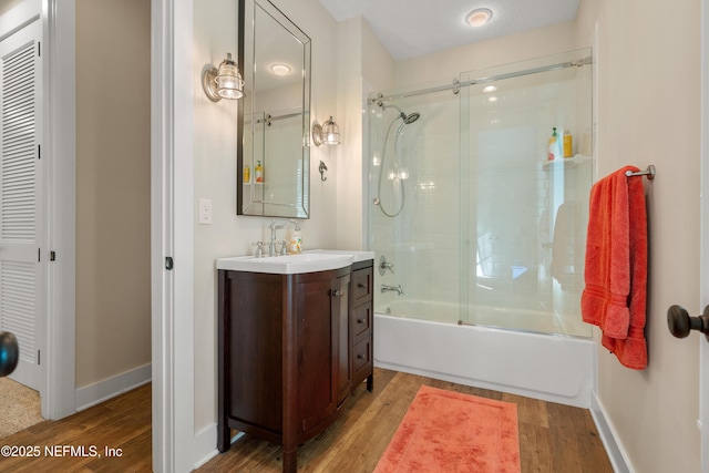 211 Tenth St, Saint Augustine, FL 32084 - bathroom with wood finished floors, vanity, and shower / bath combination with glass door