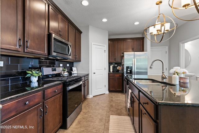 11286 Minnetta Ct, Jacksonville, FL 32256 - kitchen featuring appliances with stainless steel finishes, a sink, backsplash, dark stone countertops, and recessed lighting