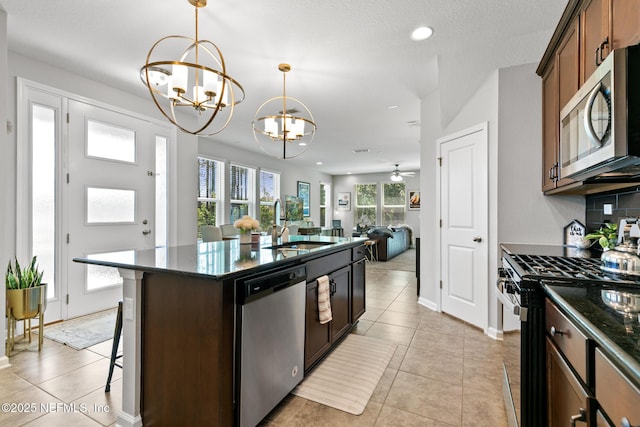 11286 Minnetta Ct, Jacksonville, FL 32256 - kitchen with appliances with stainless steel finishes, a chandelier, a sink, backsplash, and an island with sink