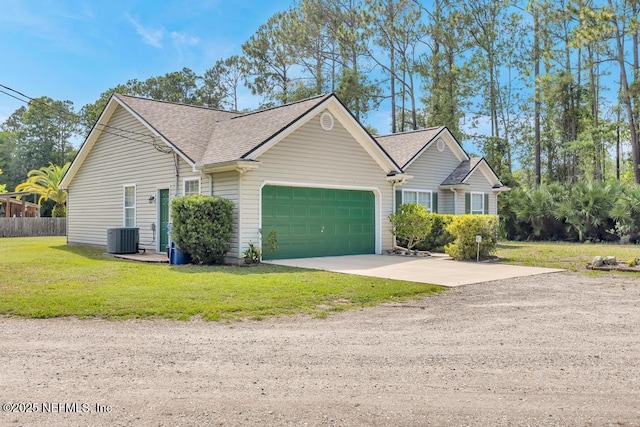 7041 Catlett Rd, Saint Augustine, FL 32095 - view of front of home featuring central air condition unit, driveway, an attached garage, roof with shingles, and a front lawn
