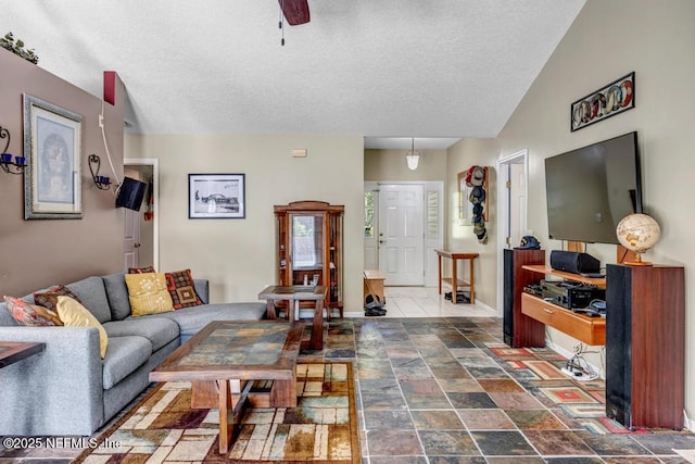7041 Catlett Rd, Saint Augustine, FL 32095 - living area featuring a textured ceiling, stone finish floors, baseboards, and a ceiling fan