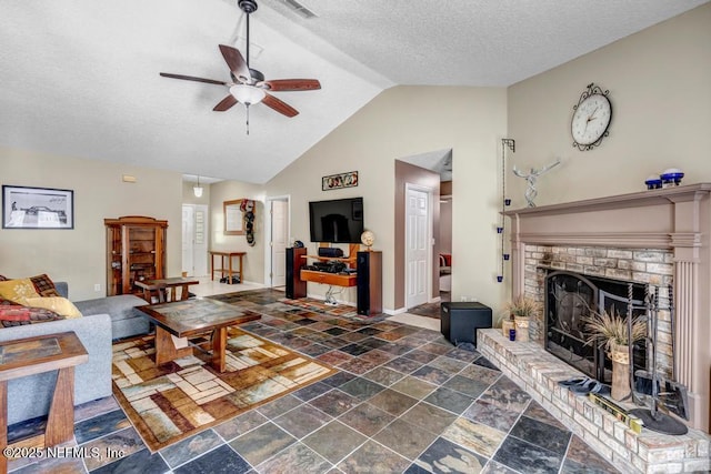 7041 Catlett Rd, Saint Augustine, FL 32095 - living room with stone tile floors, a ceiling fan, lofted ceiling, a textured ceiling, and a fireplace