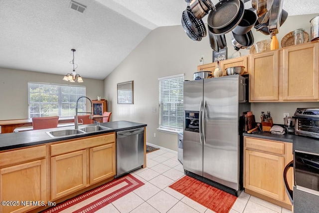 7041 Catlett Rd, Saint Augustine, FL 32095 - kitchen featuring appliances with stainless steel finishes, a sink, light brown cabinets, dark countertops, and a textured ceiling