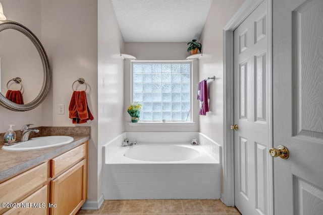7041 Catlett Rd, Saint Augustine, FL 32095 - bathroom featuring vanity, a garden tub, tile patterned floors, and a textured ceiling