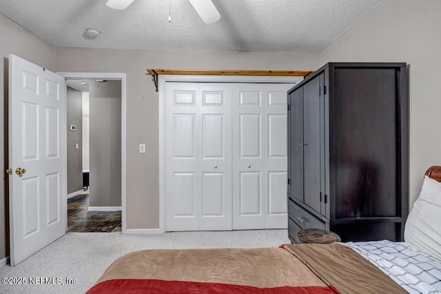 7041 Catlett Rd, Saint Augustine, FL 32095 - bedroom with carpet flooring, a textured ceiling, baseboards, ceiling fan, and a closet
