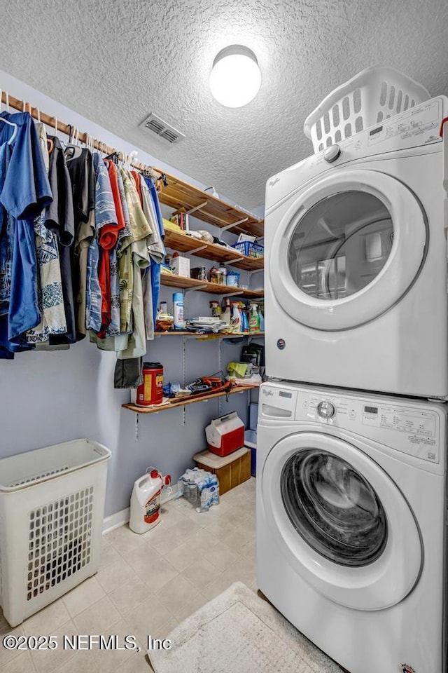 7041 Catlett Rd, Saint Augustine, FL 32095 - laundry room with stacked washer and clothes dryer and a textured ceiling