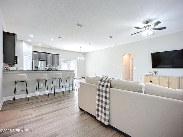 9413 Alma St, Jacksonville, FL 32220 - living room featuring arched walkways, light wood-type flooring, a ceiling fan, recessed lighting, and baseboards