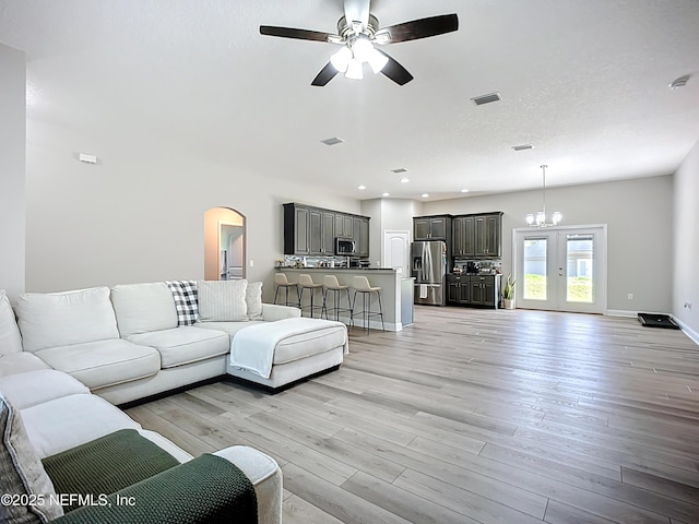 9413 Alma St, Jacksonville, FL 32220 - living area featuring light wood-style floors, a ceiling fan, arched walkways, recessed lighting, and baseboards