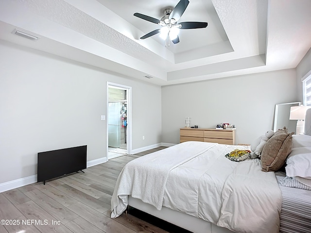 9413 Alma St, Jacksonville, FL 32220 - bedroom with a raised ceiling, light wood-style flooring, baseboards, and ceiling fan