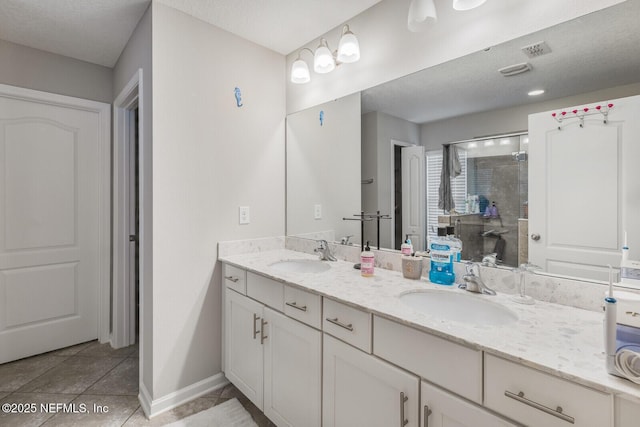 380 Crescent Key Dr, Saint Augustine, FL 32086 - bathroom featuring double vanity, a stall shower, tile patterned flooring, and baseboards