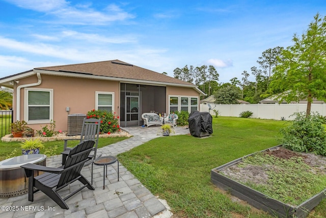 380 Crescent Key Dr, Saint Augustine, FL 32086 - rear view of property featuring a patio, stucco siding, central AC, a vegetable garden, and a sunroom