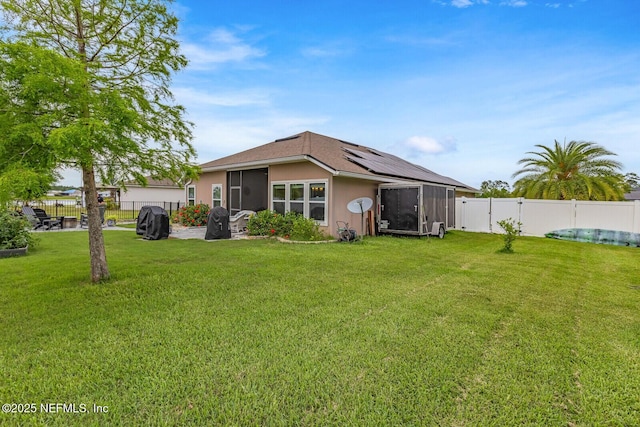 380 Crescent Key Dr, Saint Augustine, FL 32086 - back of property with roof mounted solar panels, a sunroom, and stucco siding