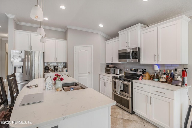 380 Crescent Key Dr, Saint Augustine, FL 32086 - kitchen with stainless steel appliances, crown molding, backsplash, recessed lighting, and white cabinetry