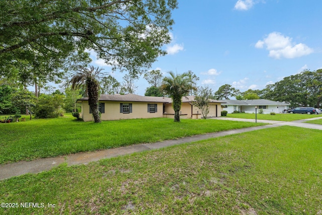 419 Sevilla Dr, Saint Augustine, FL 32086 - ranch-style home with an attached garage, driveway, and a front lawn