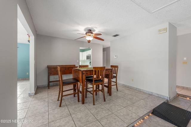419 Sevilla Dr, Saint Augustine, FL 32086 - dining area with a ceiling fan, light tile patterned floors, a textured ceiling, and baseboards
