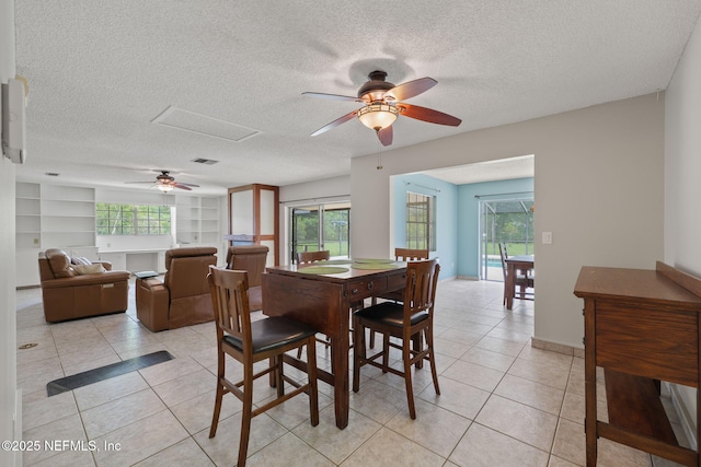 419 Sevilla Dr, Saint Augustine, FL 32086 - dining room featuring a ceiling fan, plenty of natural light, light tile patterned floors, and a textured ceiling