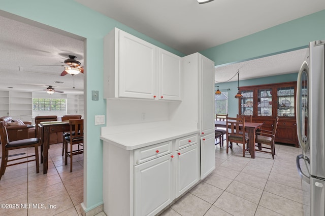 419 Sevilla Dr, Saint Augustine, FL 32086 - kitchen with freestanding refrigerator, a ceiling fan, light tile patterned floors, a textured ceiling, and light countertops