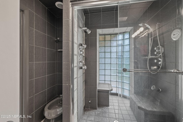 419 Sevilla Dr, Saint Augustine, FL 32086 - bathroom with a tile shower, tile patterned flooring, and tile walls