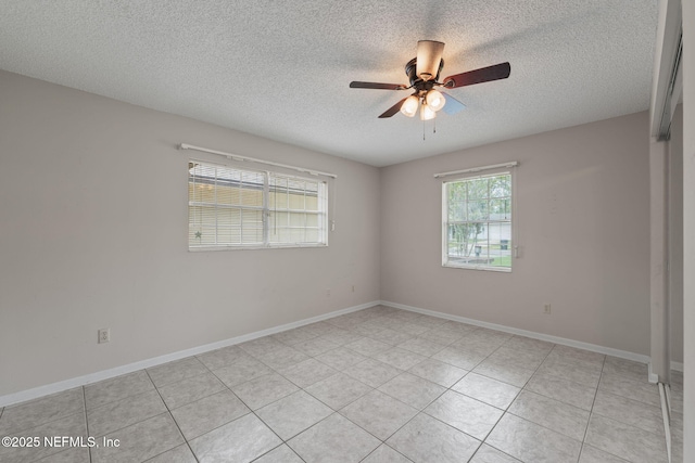 419 Sevilla Dr, Saint Augustine, FL 32086 - unfurnished room with a textured ceiling, a ceiling fan, light tile patterned floors, and baseboards