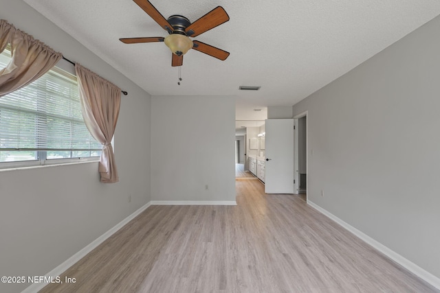 419 Sevilla Dr, Saint Augustine, FL 32086 - unfurnished room with light wood-type flooring, a ceiling fan, baseboards, and a textured ceiling